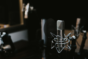 Photo of a recording studio, with microphone in the foreground